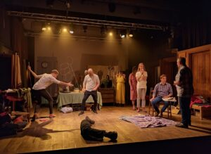Lucid origin A lively theater rehearsal on a softly lit stage. Several actors in motion one p